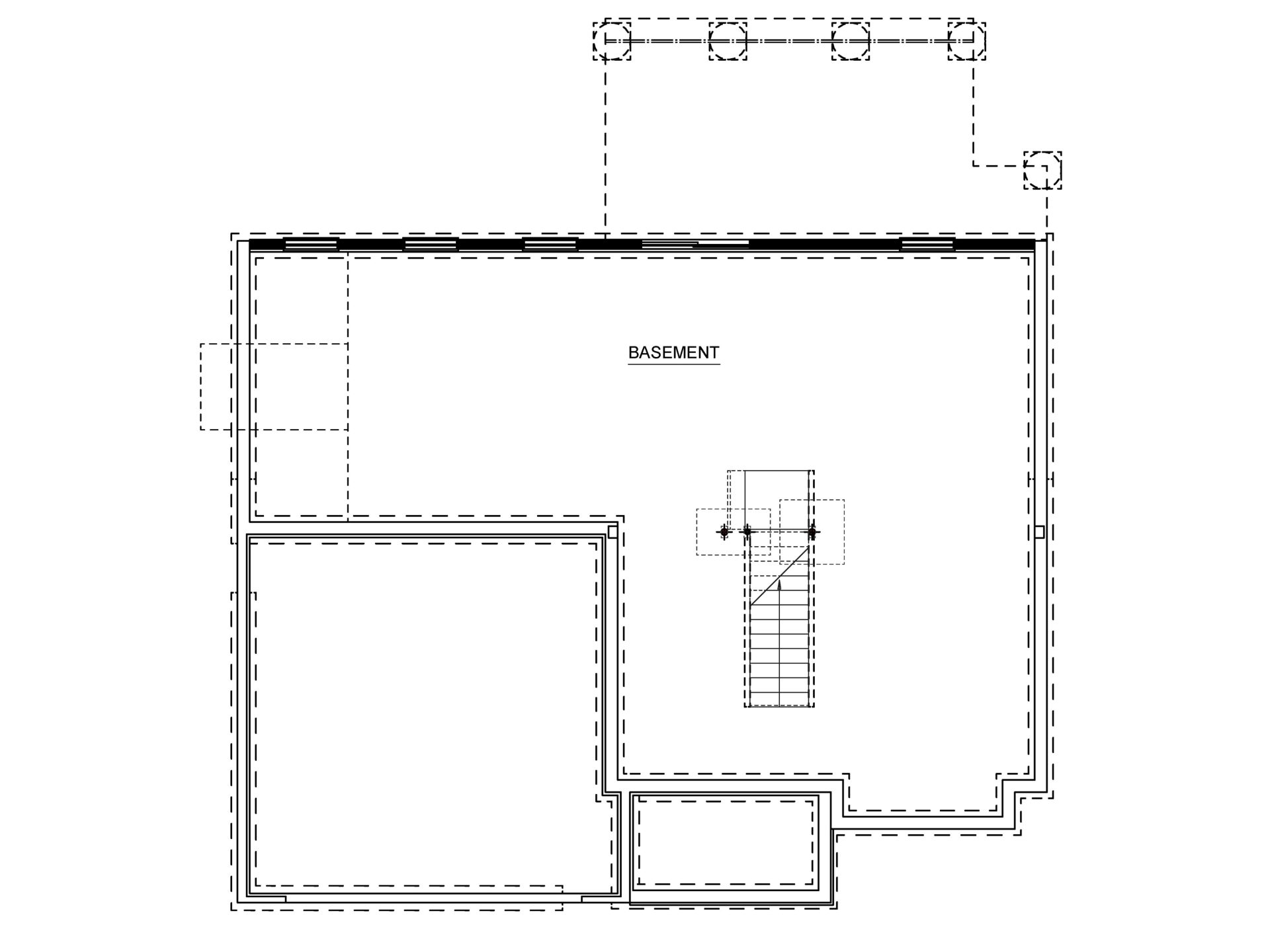 Unfinished basement floor plan showing an open layout, central staircase and foundation walls.